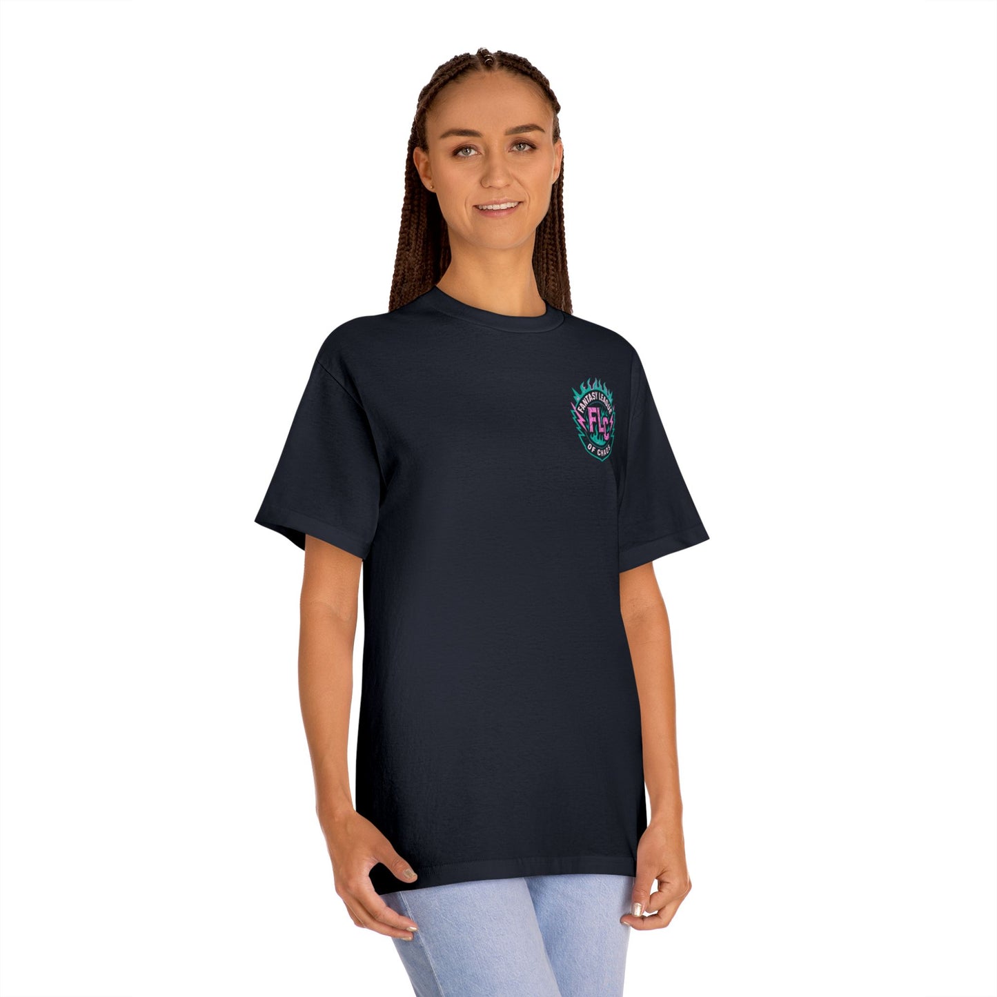 A woman with long braids wears the Printify Unisex Classic Tee featuring a small, colorful Dripball Design on the left chest, paired with light blue jeans, standing and smiling in front of a plain white background.