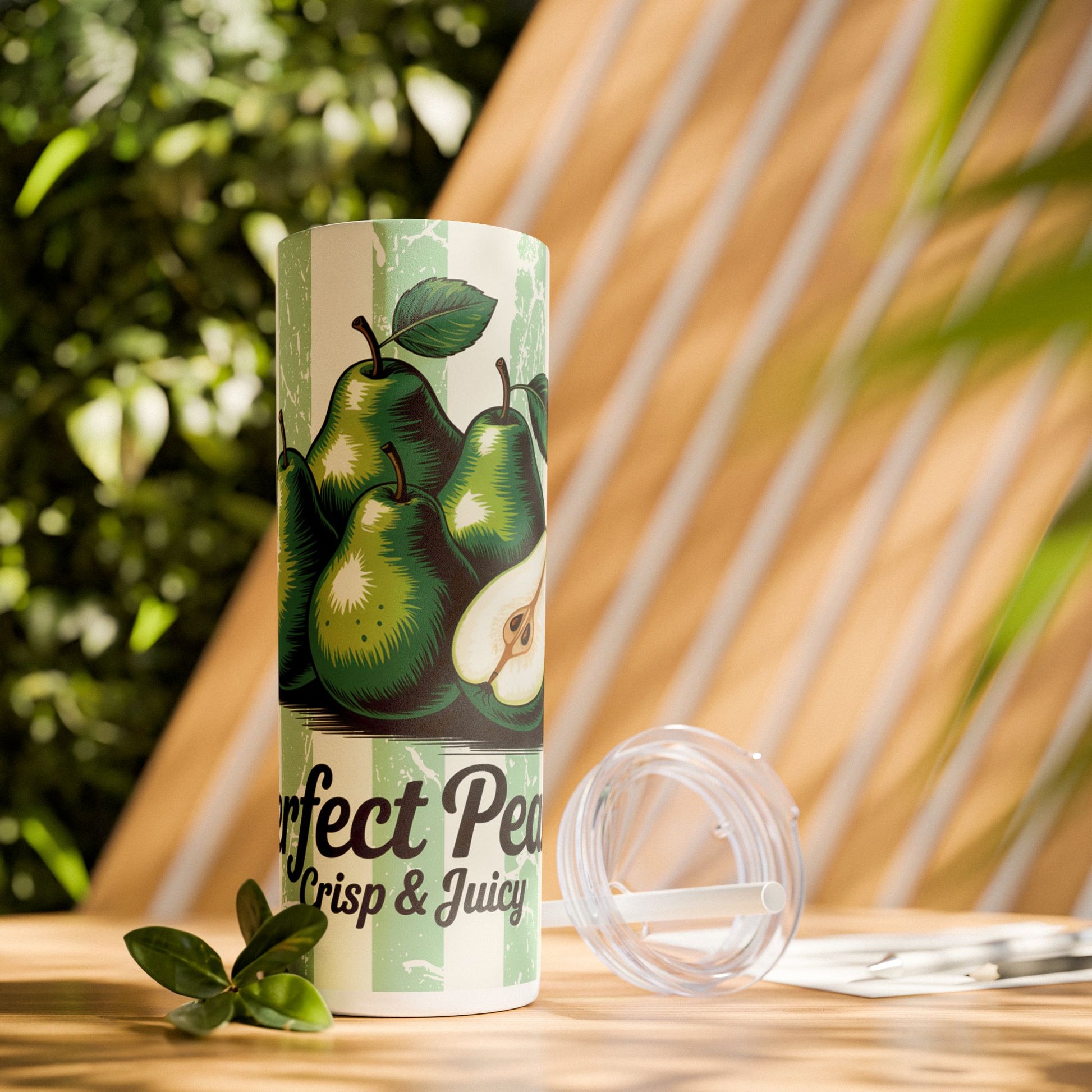 20Oz Perfect Pear Skinny Tumbler with Straw set against a lush background, representing stylish vacation drinkware essentials.
